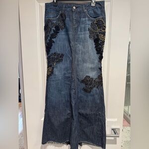 Bebe Denim Long Skirt with lace and embroidered flower details.